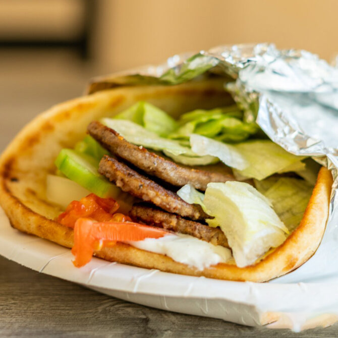 Gyro on pita with lettuce, tomato and sauce