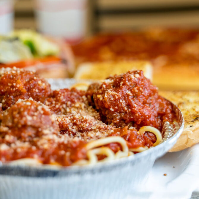 Spaghetti and meatballs with sauce and grated cheese