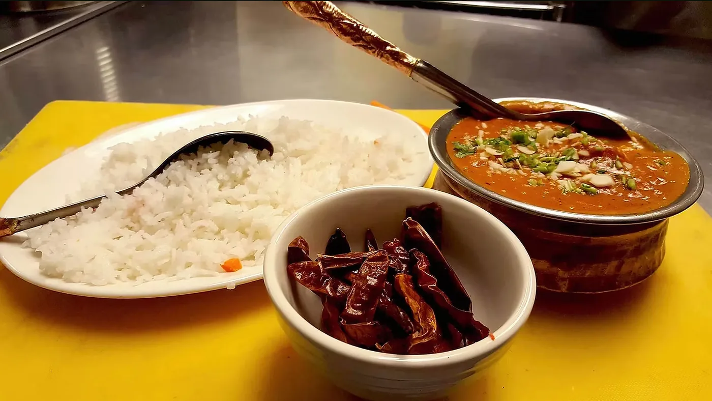 Curry served with rice and dried chilies