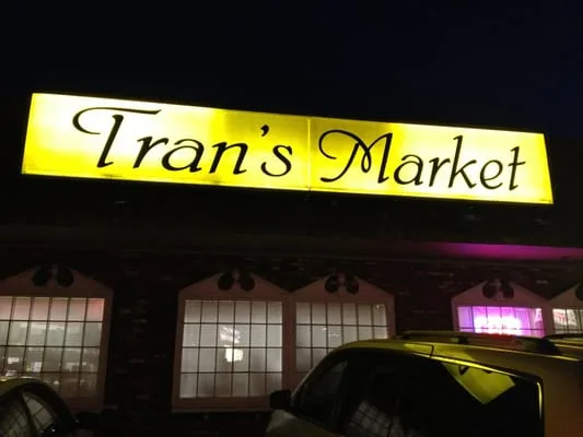 Tran's Market storefront sign at night